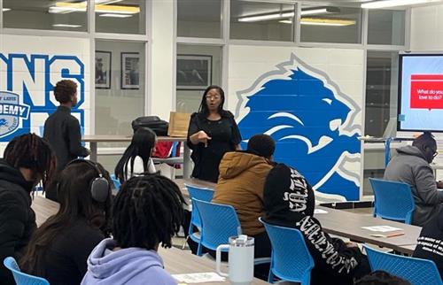 Woman speaking to a group of students